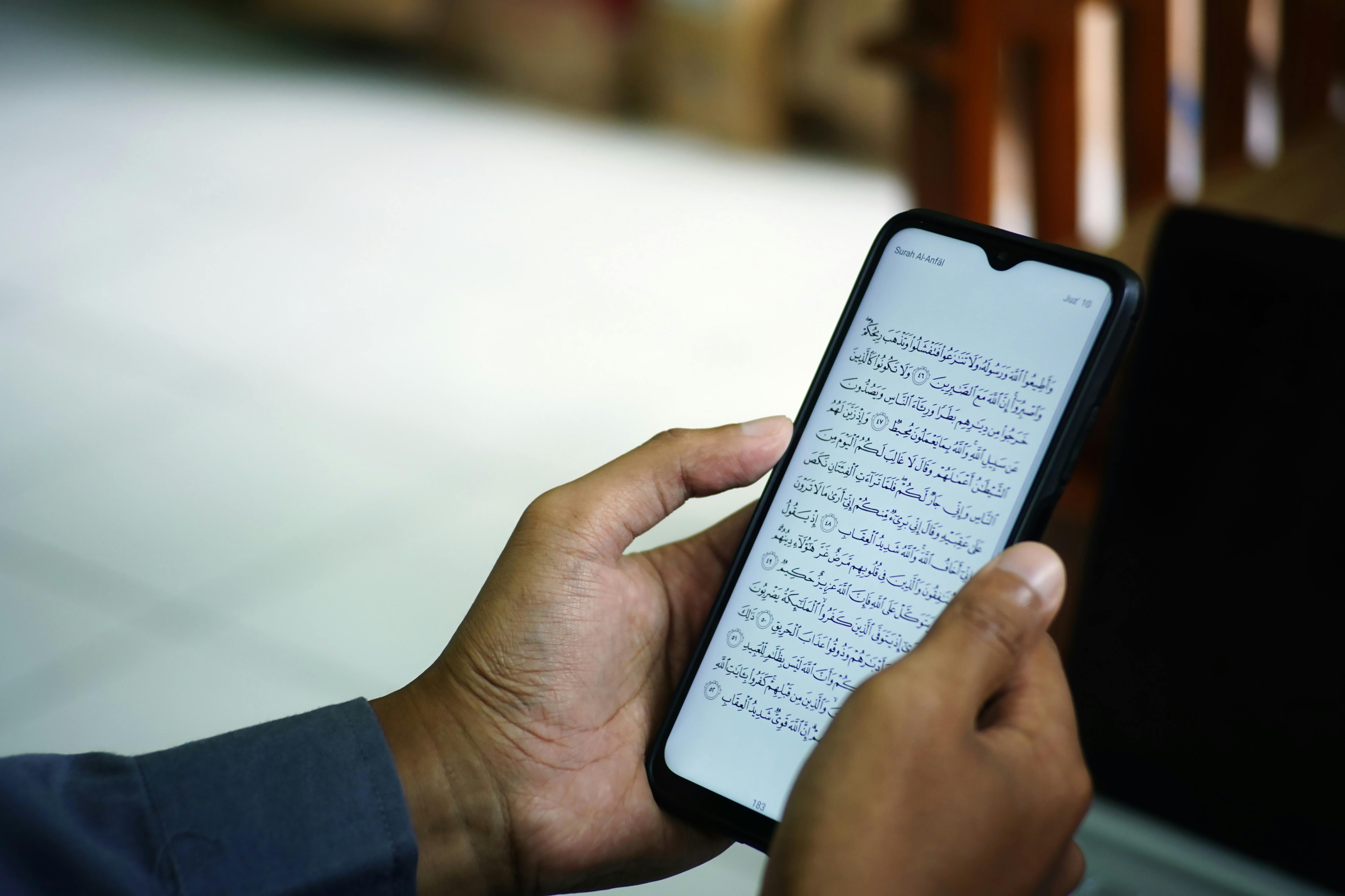 A smartphone displaying a Quran app alongside server infrastructure graphics, symbolizing the hidden costs behind digital Islamic tools